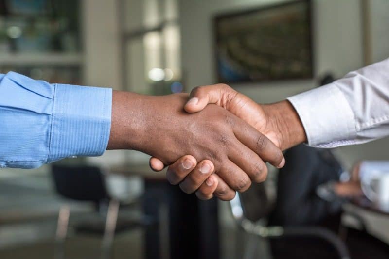 A handshake, representing collaboration within the team