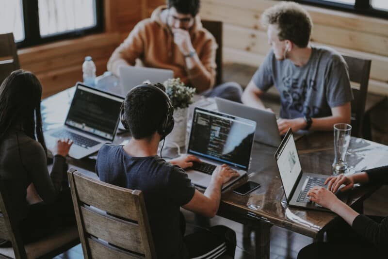 A group of people each working on their own laptop, like a distributed remote team